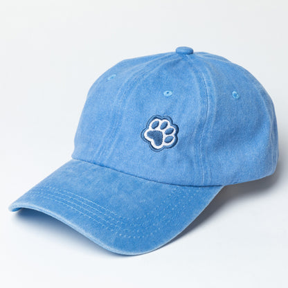 Blue baseball cap with navy blue paw print embroidered on the front