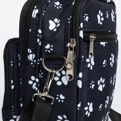 Black bag with white paw prints and a metal clasp on a white background