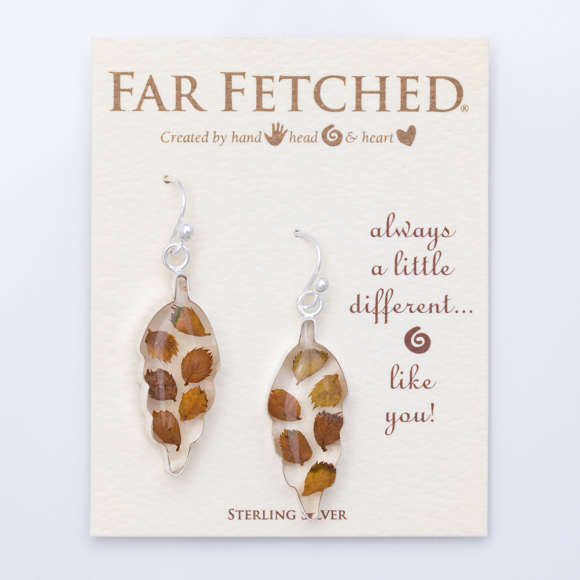 Pair of leaf-shaped earrings on a 'Far Fetched' branded card with text.