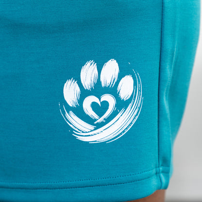 Teal shorts with a white paw print design on a plain background.