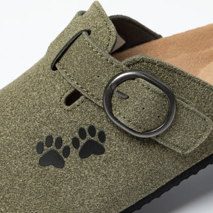 Close-up of green clog with a buckle and printed paw prints.