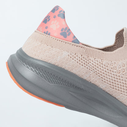Light pink sneaker with paw print accents on a cushioned heel, against a light gray background