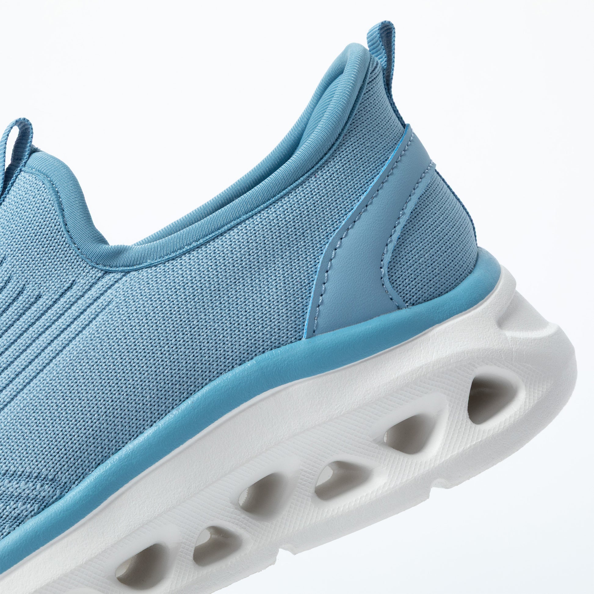 Blue athletic shoe with a white shock absorbing sole on a light gray background