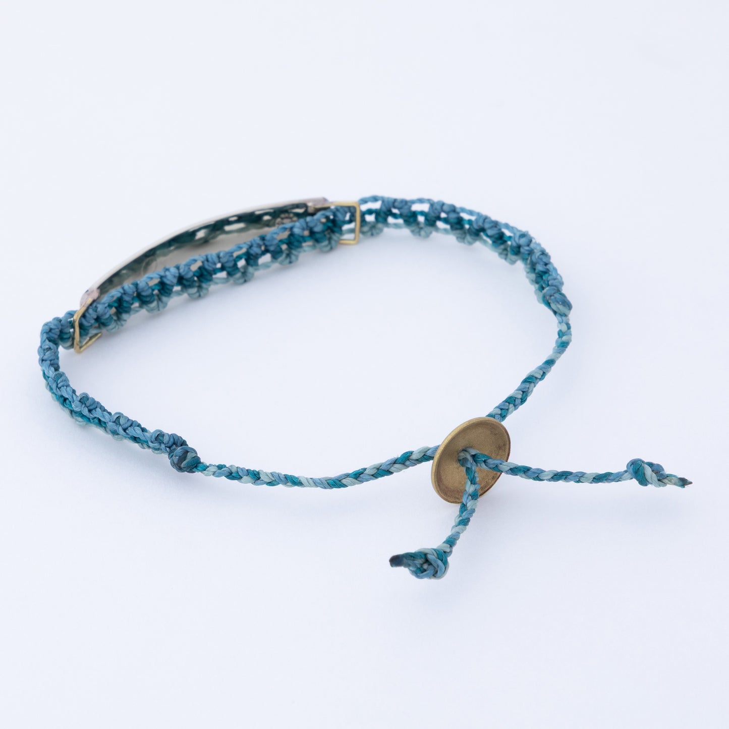 Blue braided bracelet with a gold clasp on a white background