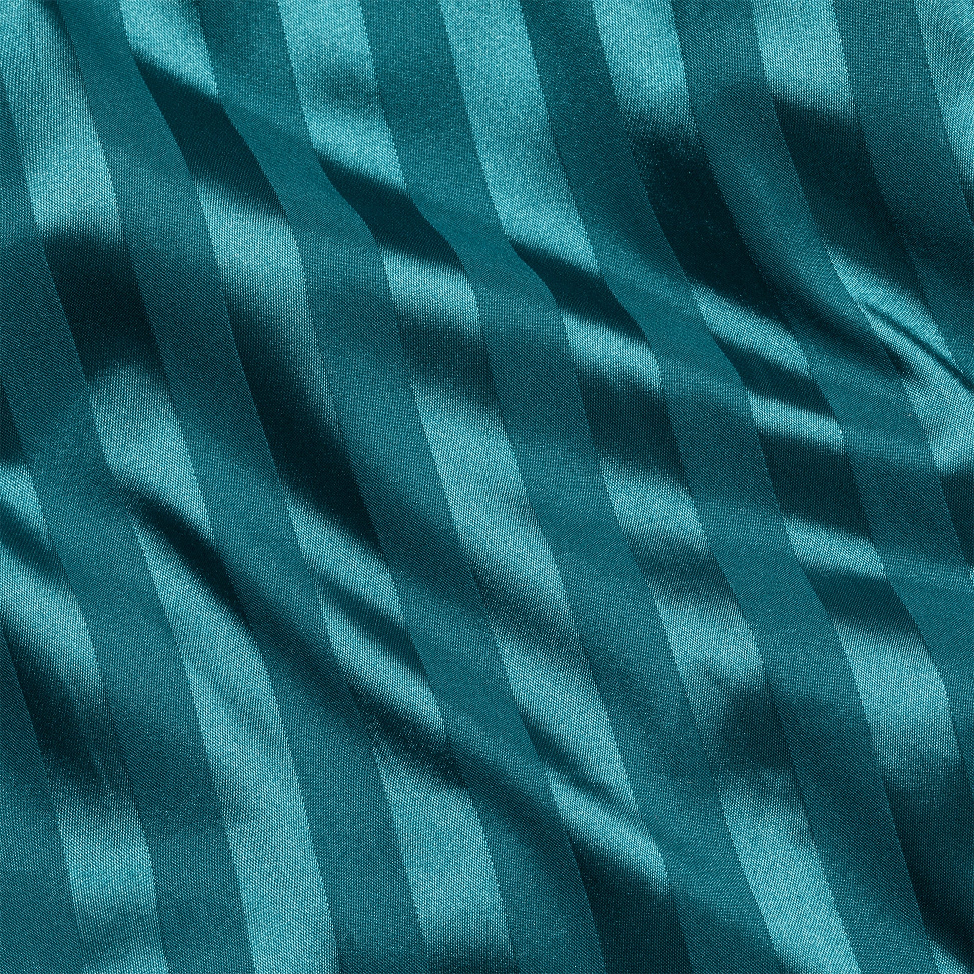 Close-up of teal satin fabric with stripes