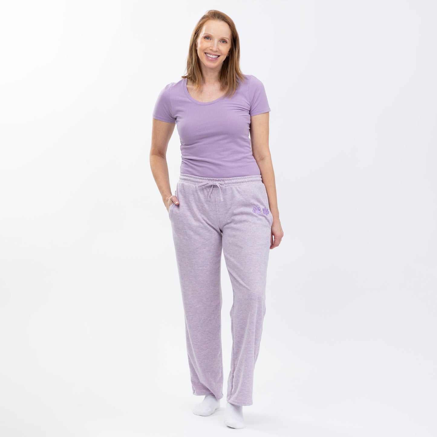 Woman wearing a purple tee with purple rib knit soft relaxed fit pants on a white background.