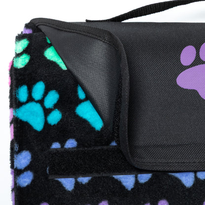 Black blanket with colorful paw prints and a black folding top with handle.