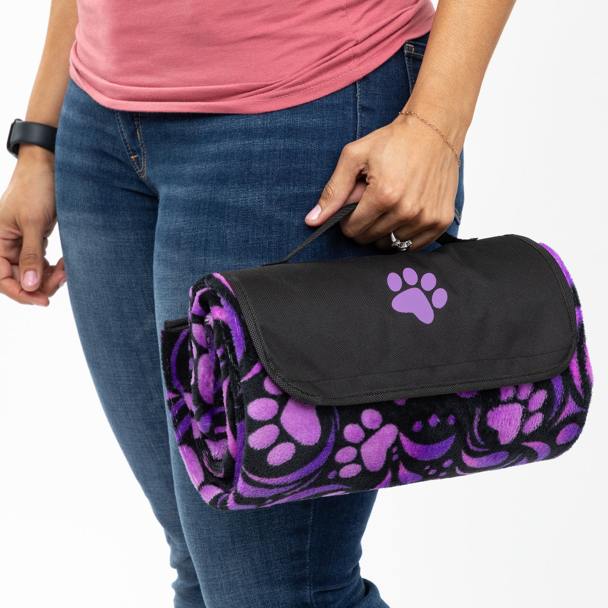 Person holding a purple and black paw print blanket