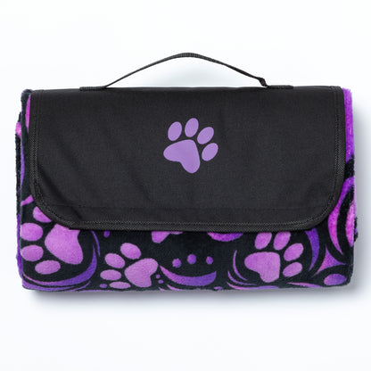 Black and purple paw print blanket with a handle on a white background