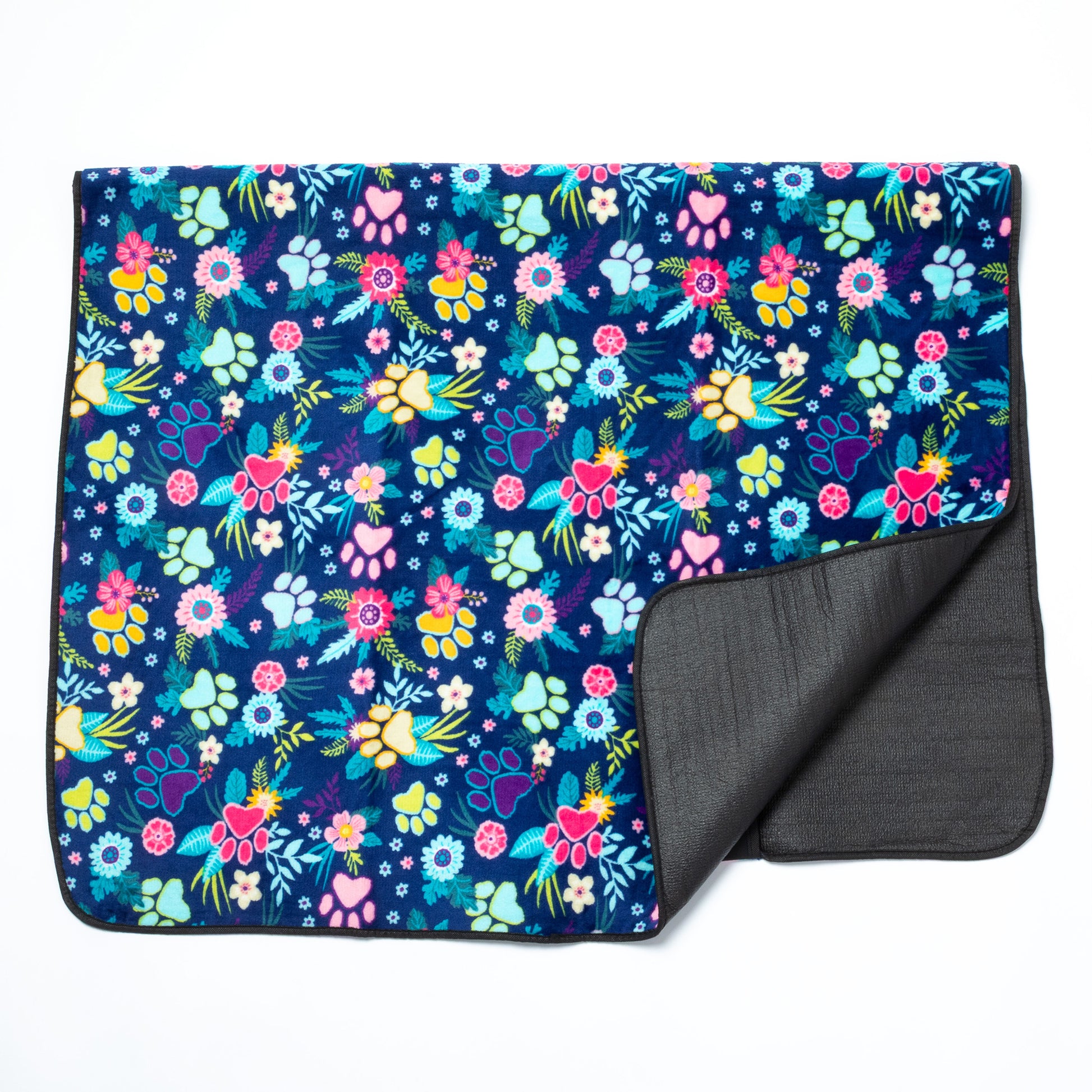 Floral patterned blanket with dark blue background and gray backside