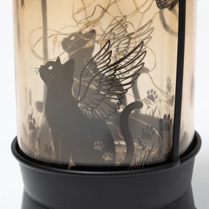Decorative lantern with a black cat silhouette and wings design.