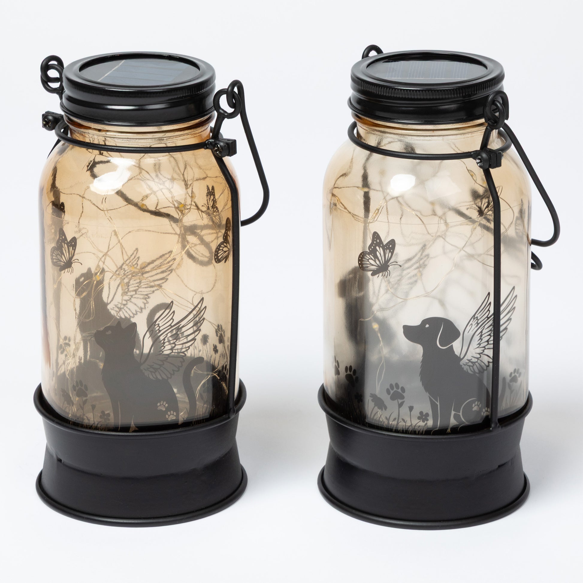 Two solar lanterns with animal silhouettes on a white background