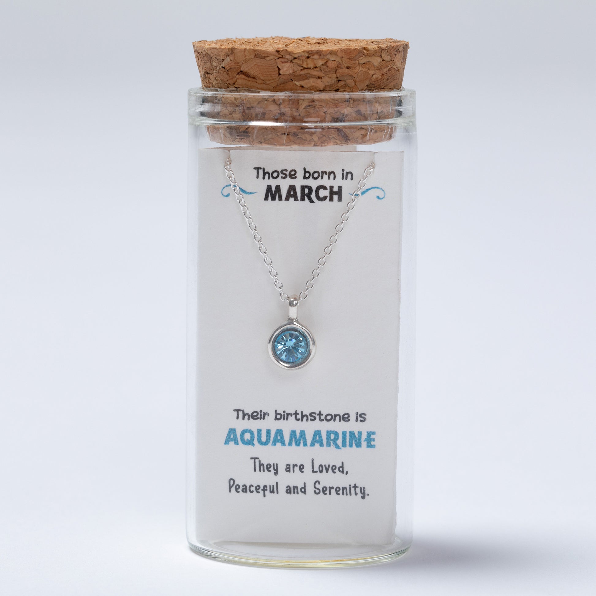 Necklace in a glass jar with a cork lid, featuring information about March birthstones on a white background.