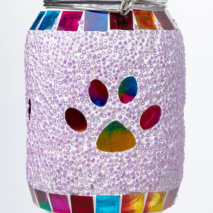 Decorative jar solar lantern with colorful paw print design on a white background