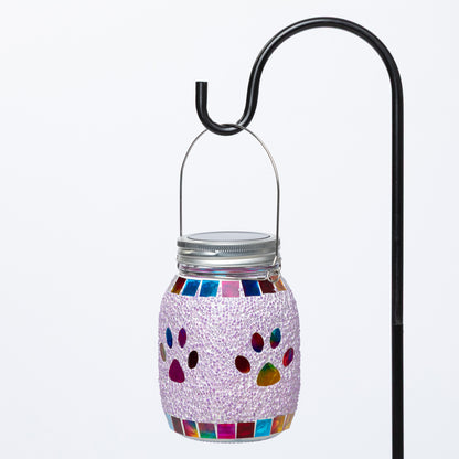 Decorative jar with colorful paw prints on a white background