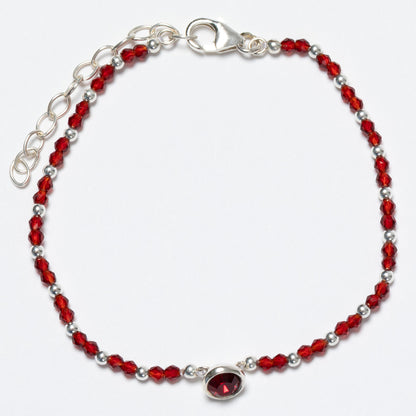 Bracelet with red and silver beads on a white background