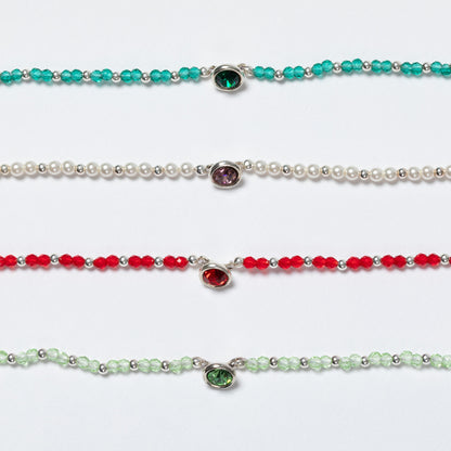 Four beaded necklaces with gemstones on a white background