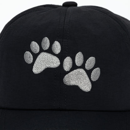 Black cap with silver paw prints on a white background