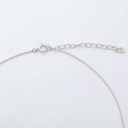 Silver chain bracelet on a light gray background