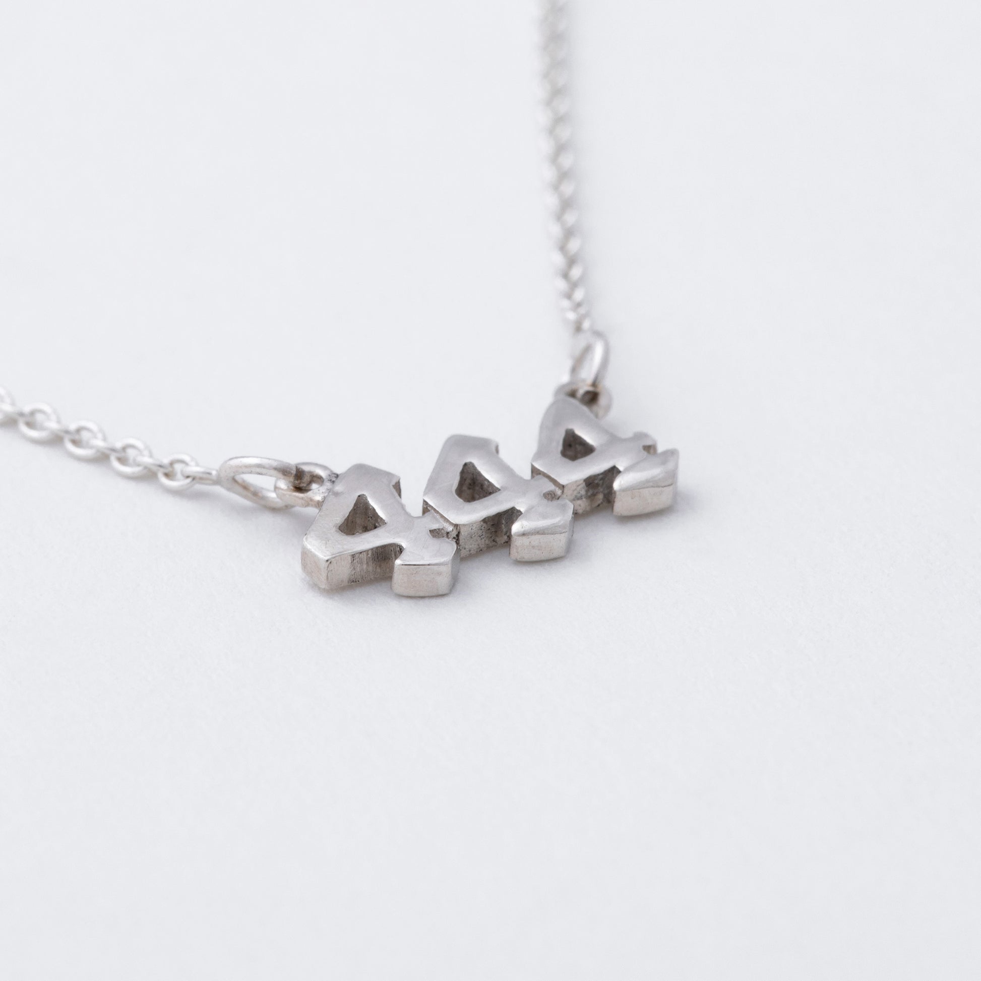 Silver necklace with a pendant on a white background