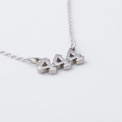 Silver necklace with a pendant on a white background