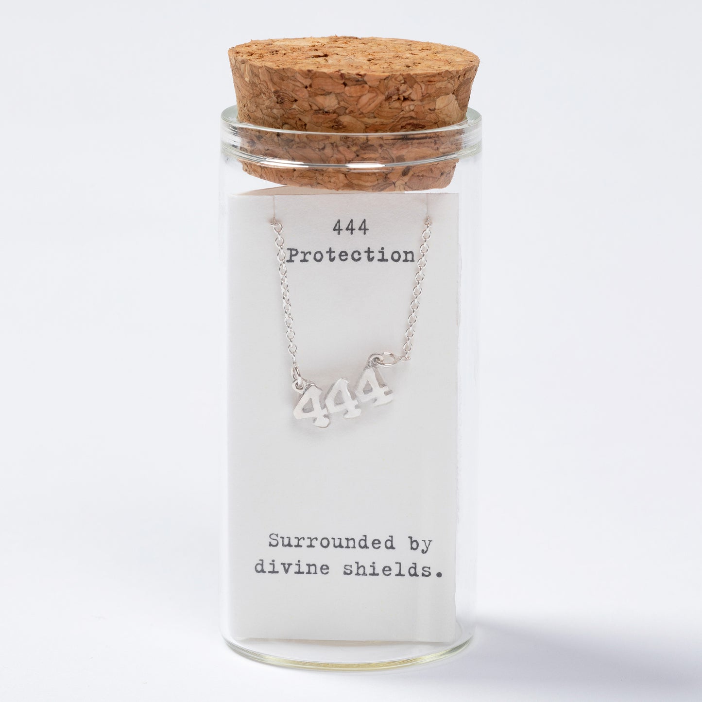 Necklace with '444' symbol in a glass jar labeled 'Protection' on a white background