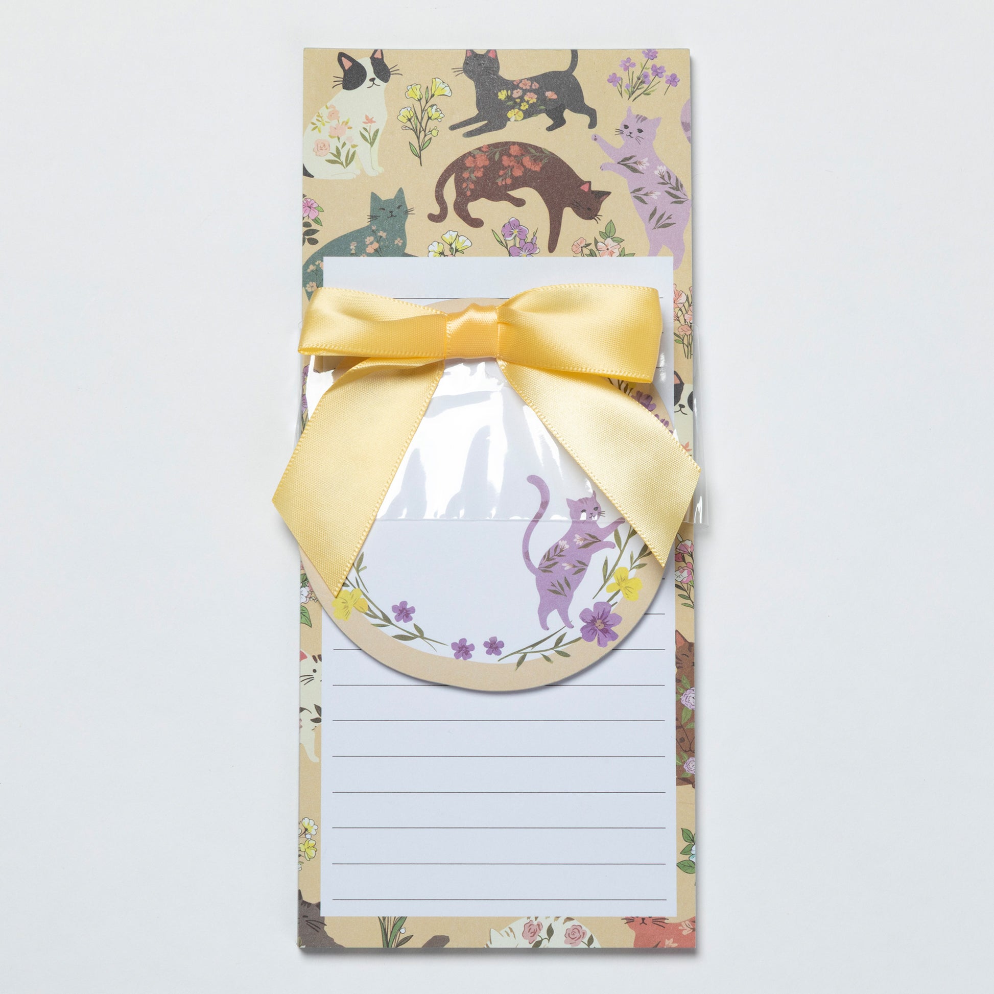Notepad with a decorative border featuring cats and flowers, tied with a yellow ribbon.