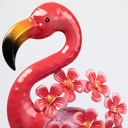 Pink flamingo metal garden stake with flowers on a white background