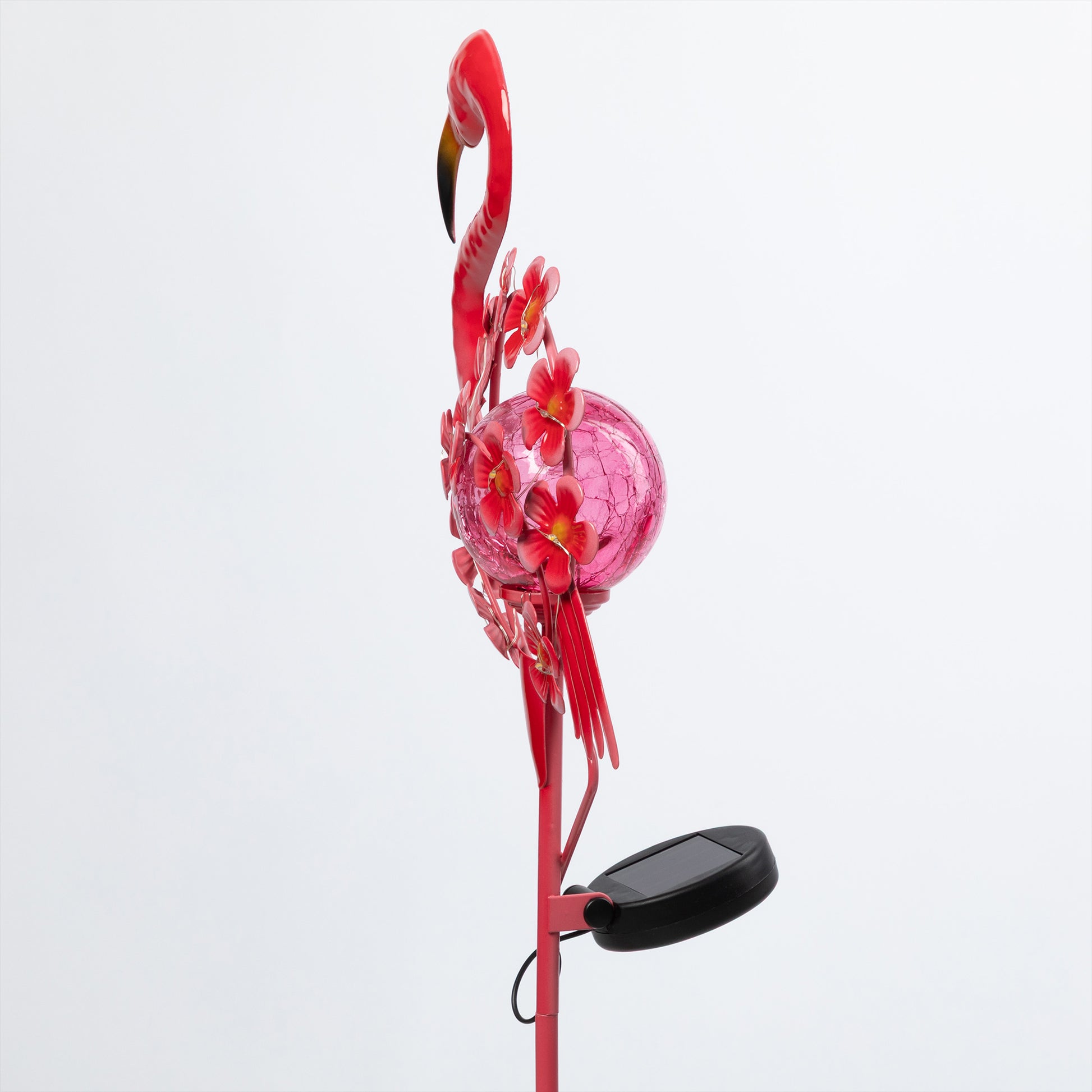 Decorative flamingo-shaped solar light with pink ball and flowers on a white background
