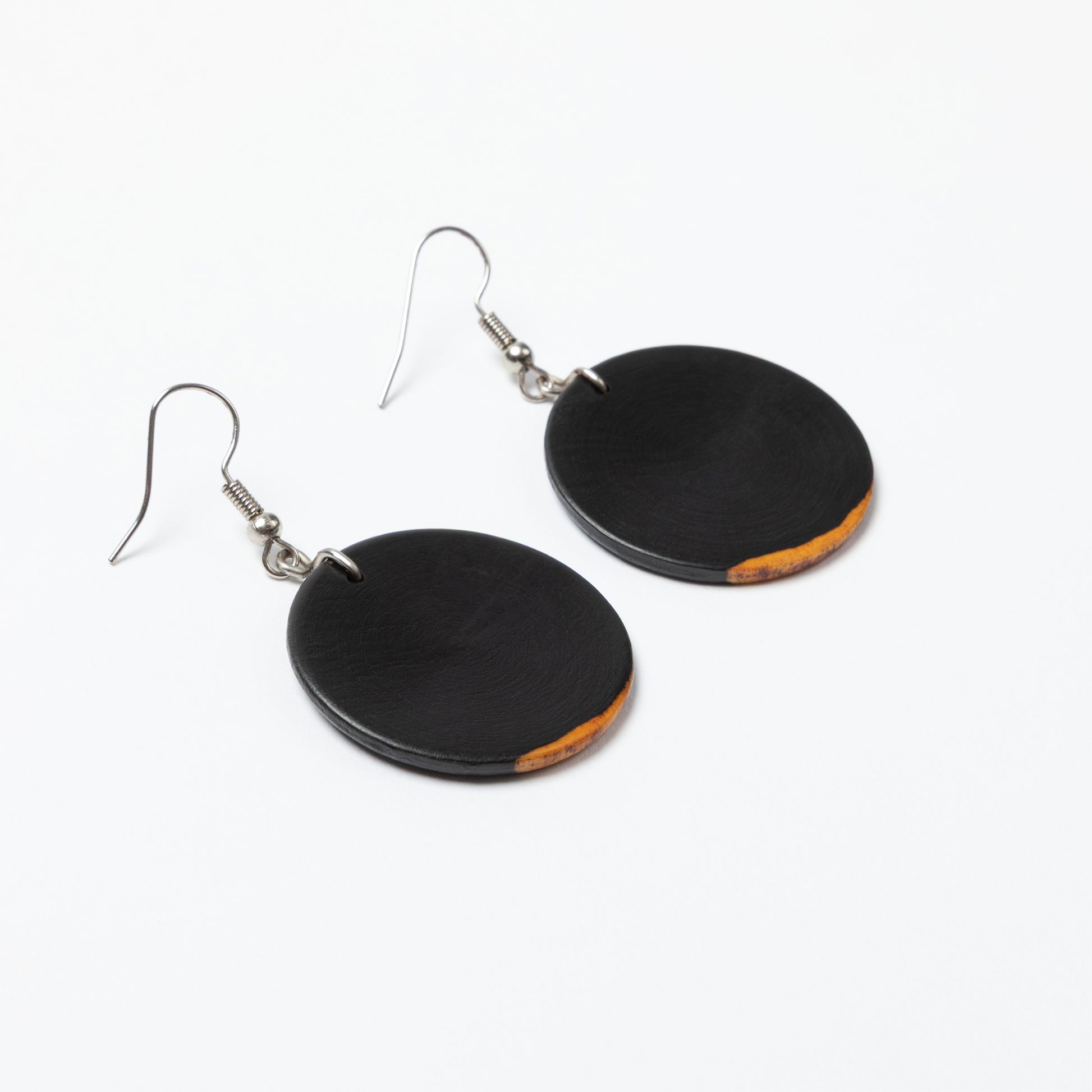 Black circular earrings on a white background