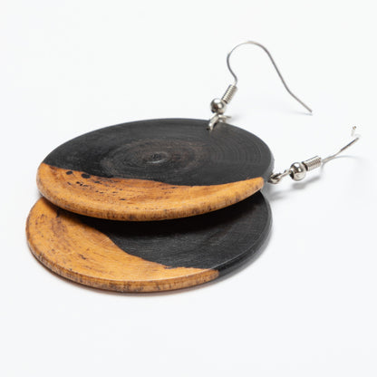 Wooden earrings with black and natural wood color on a white background