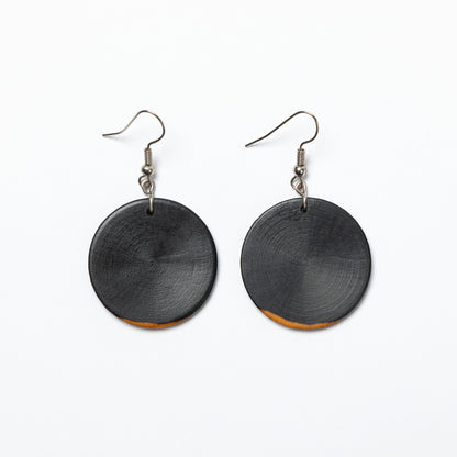 Black round wood earrings on a white background