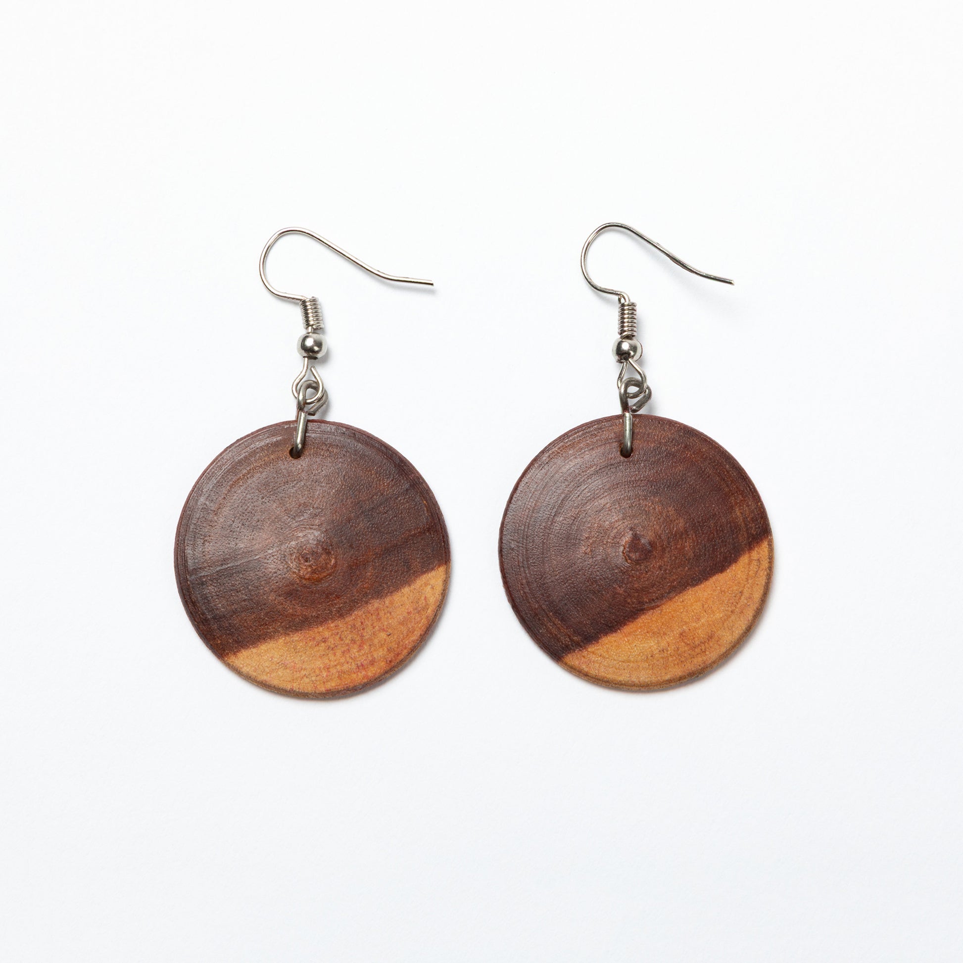 Wooden earrings with a two-tone design on a white background
