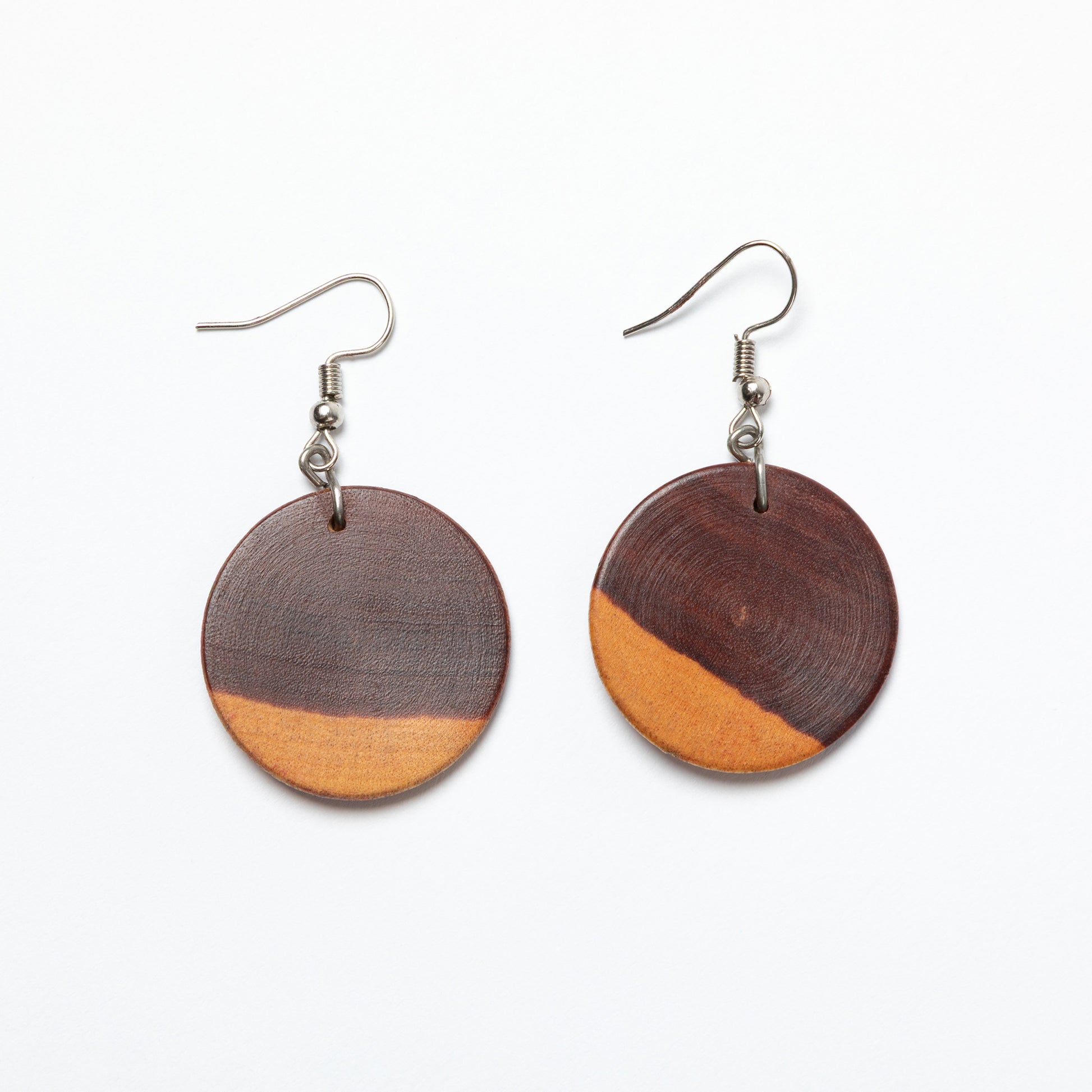 Wooden earrings with two-tone design on a white background