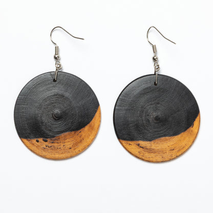 Pair of earrings with black and wood-like design on a white background