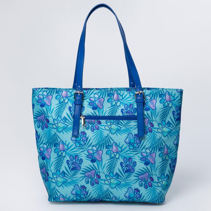 Blue tote bag with paw print pattern on a white background