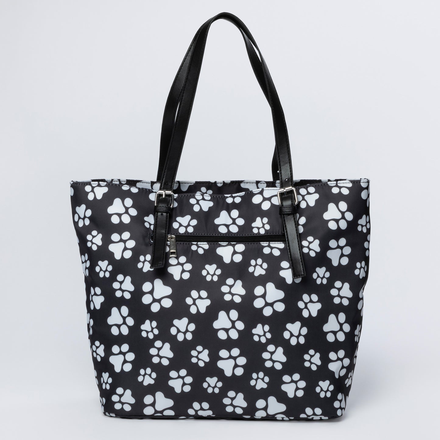Black tote bag with white paw print pattern on a light gray background