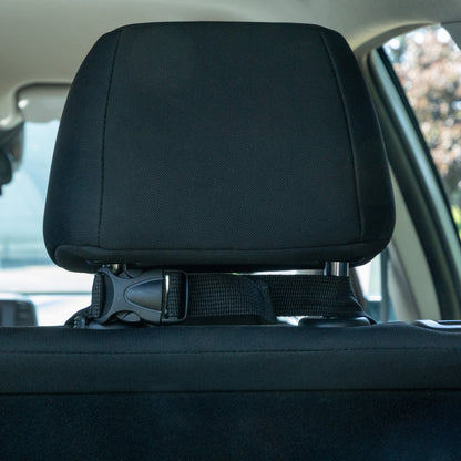Car headrest with a seatbelt buckle in a vehicle interior