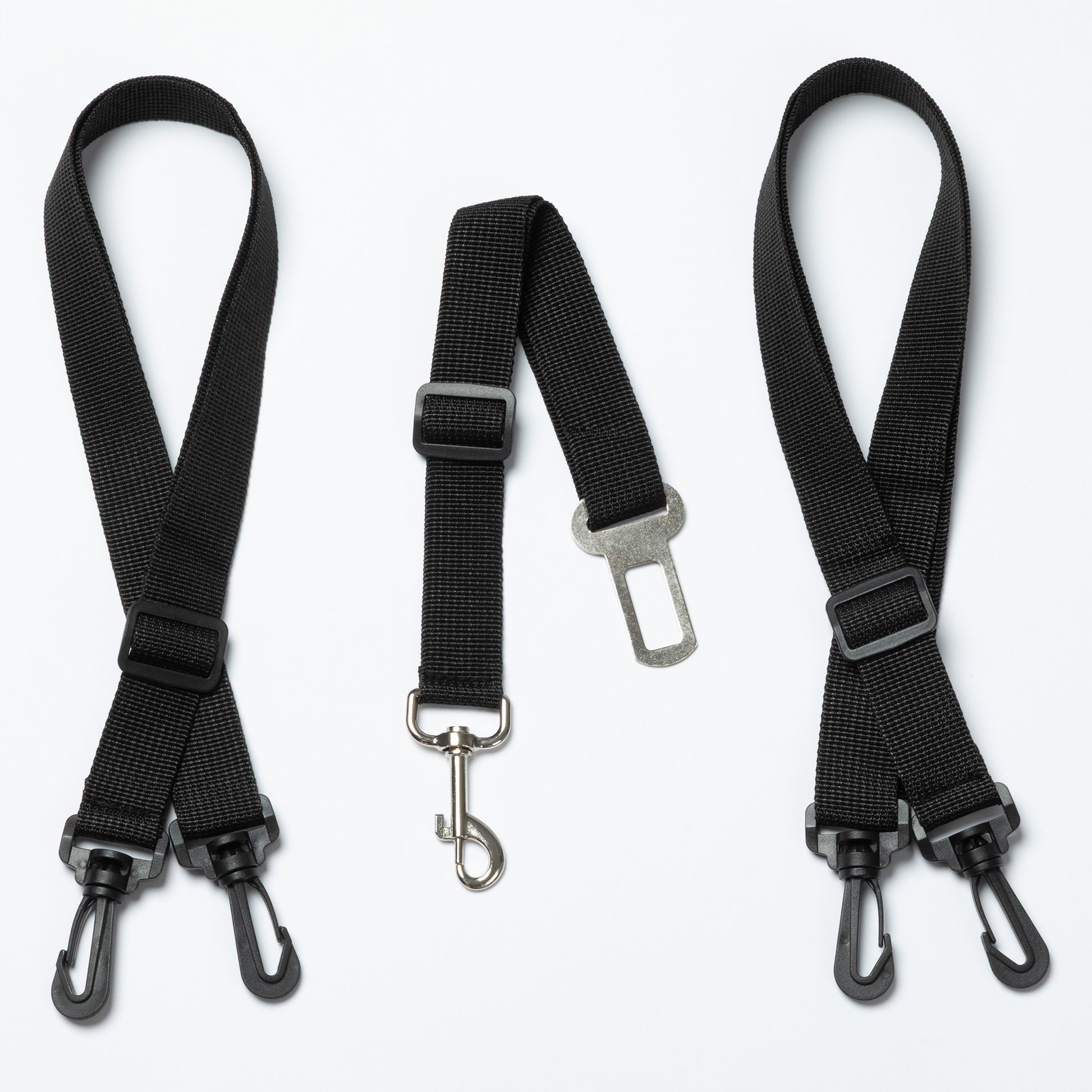 Three black seat belt straps with metal hooks on a white background