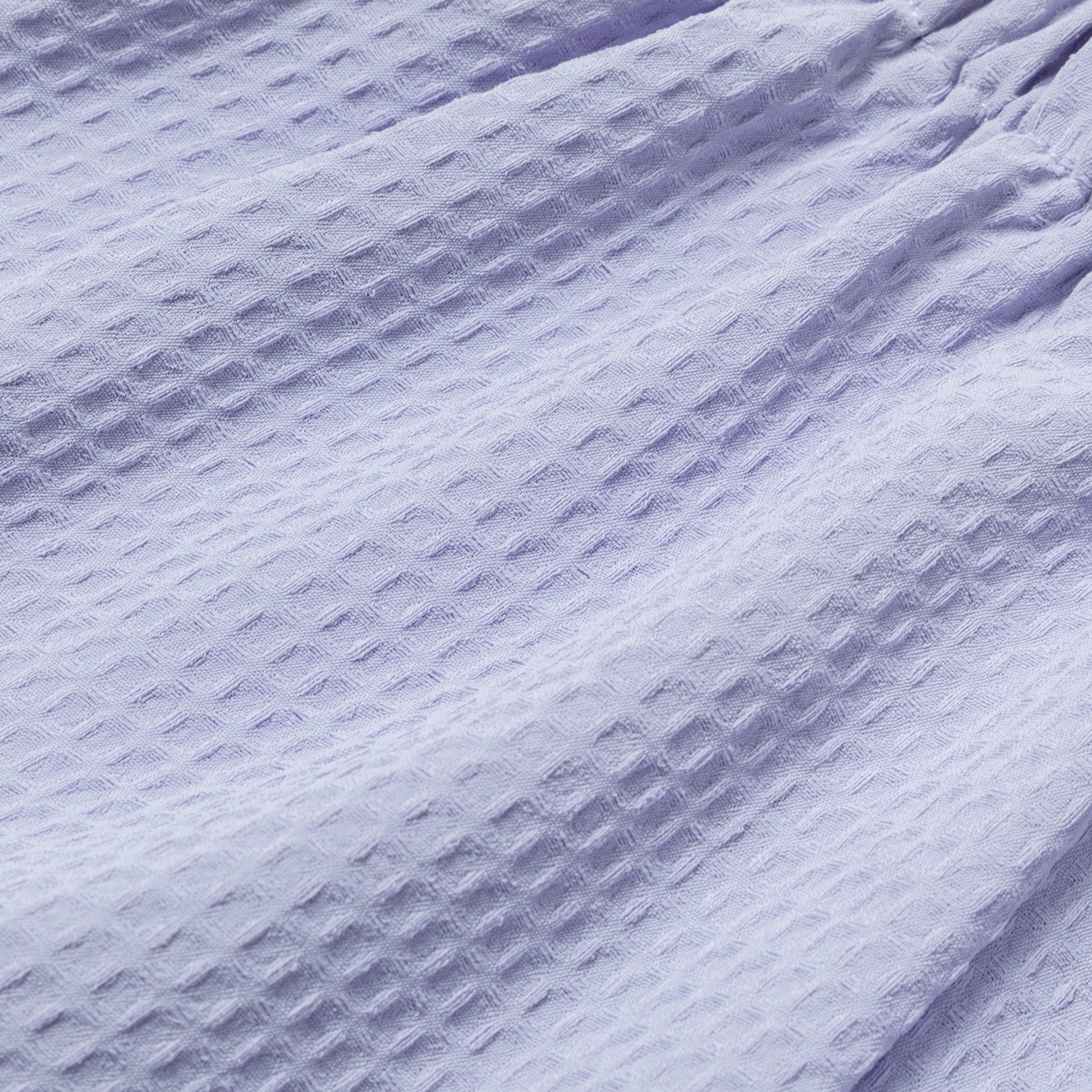 Close-up of textured waffle weave purple fabric