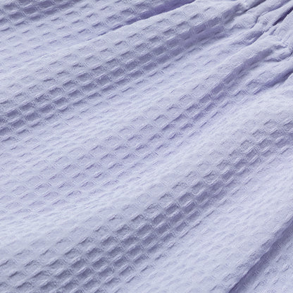 Close-up of textured waffle weave purple fabric