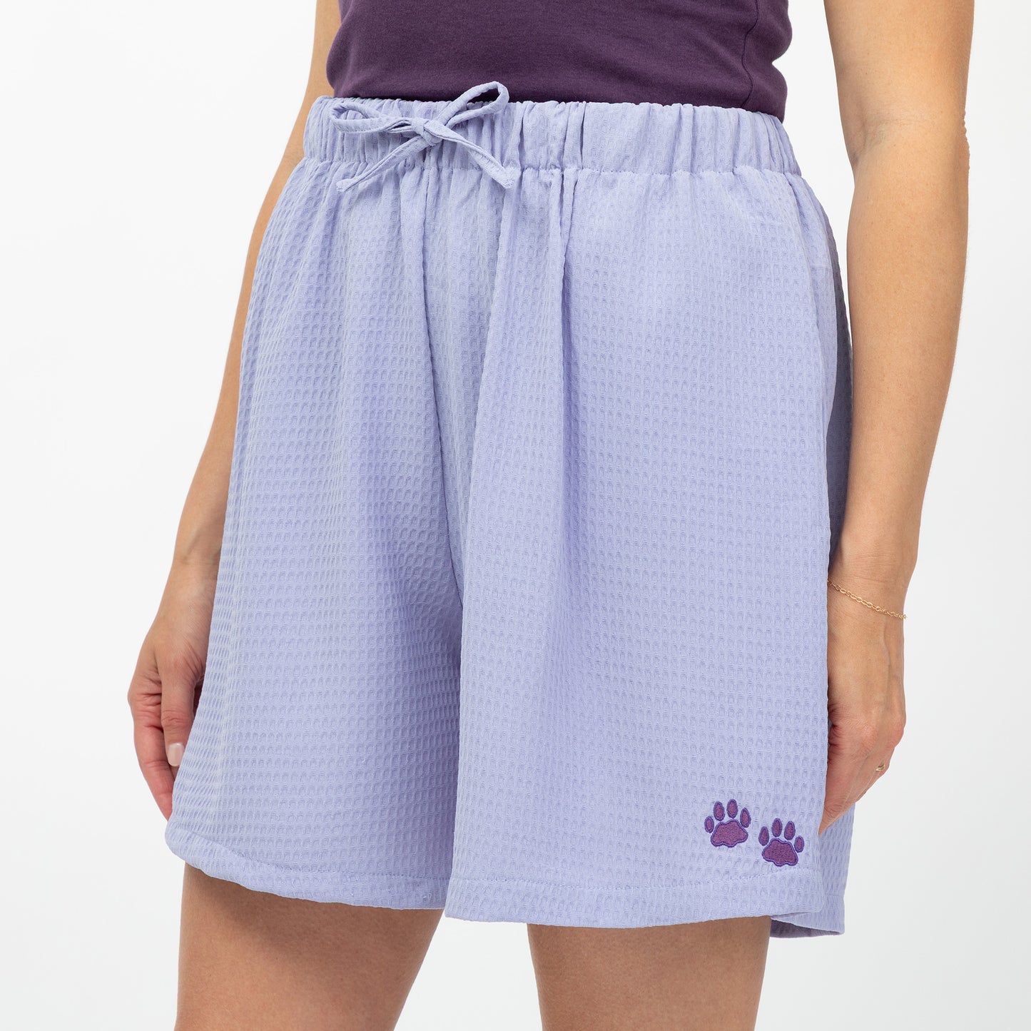 Lavender shorts with a paw print on a white background