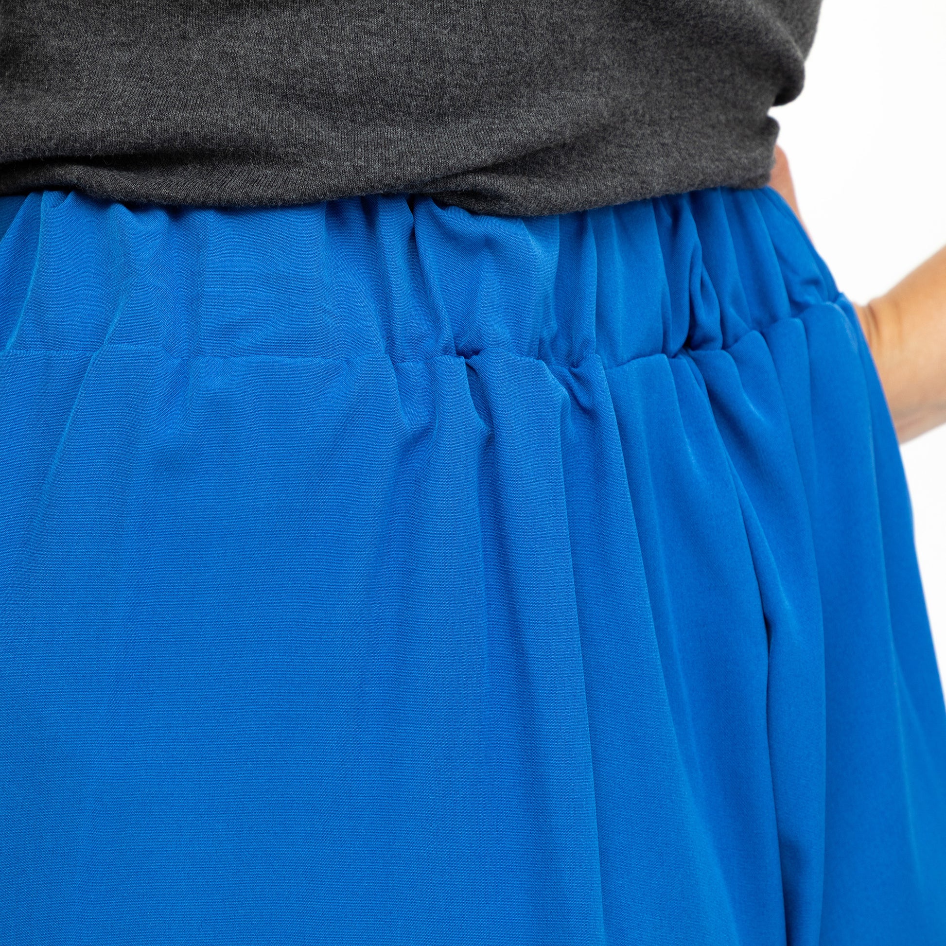 Blue shorts with a gray top on a white background