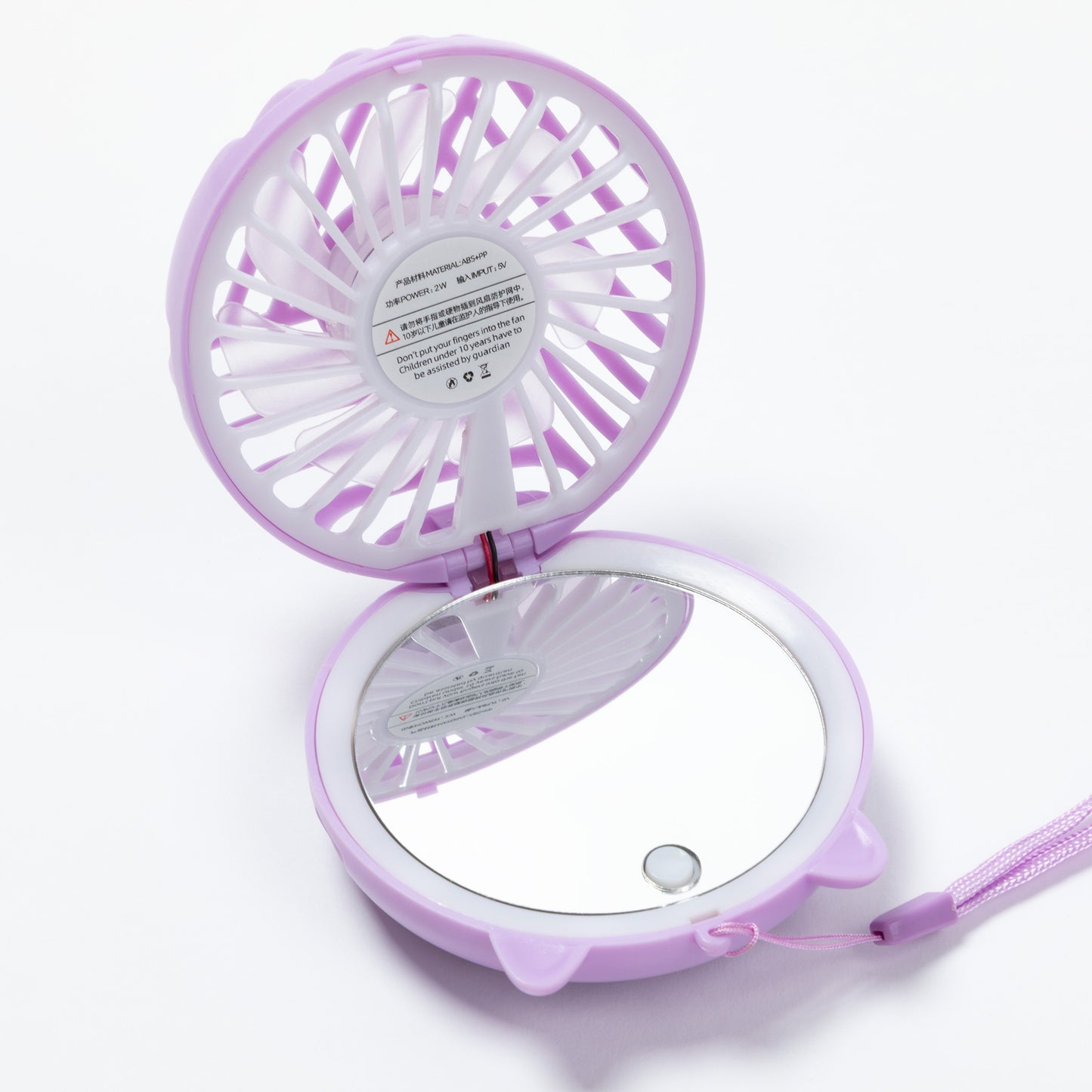 A compact, circular purple handheld fan with an attached mirror on the bottom half, shown open on a white background.