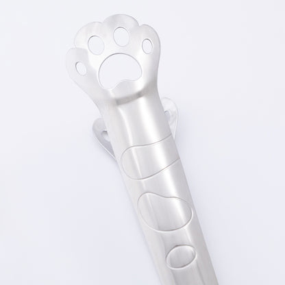Metallic paw-shaped tongs on a light gray background