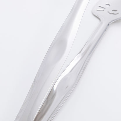 Close-up of a stainless steel tong on a light gray background