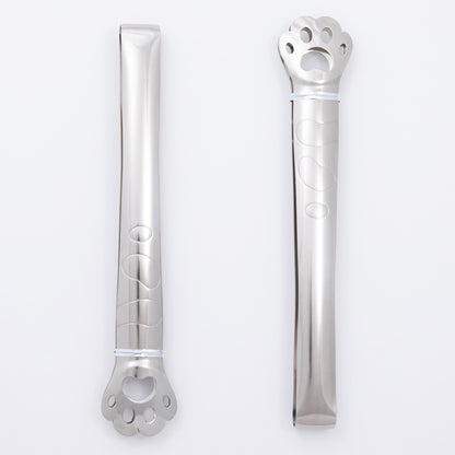 Two stainless steel paw print tongs on a white background
