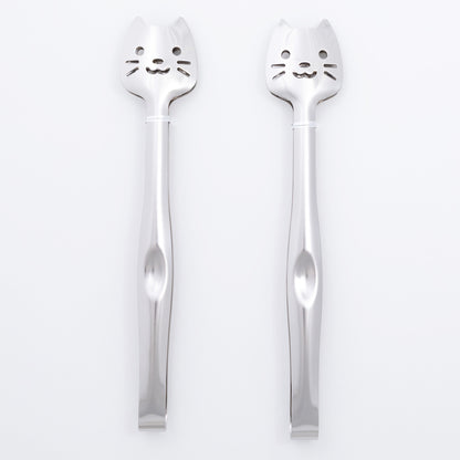 Two silver spoons with cat faces on a white background