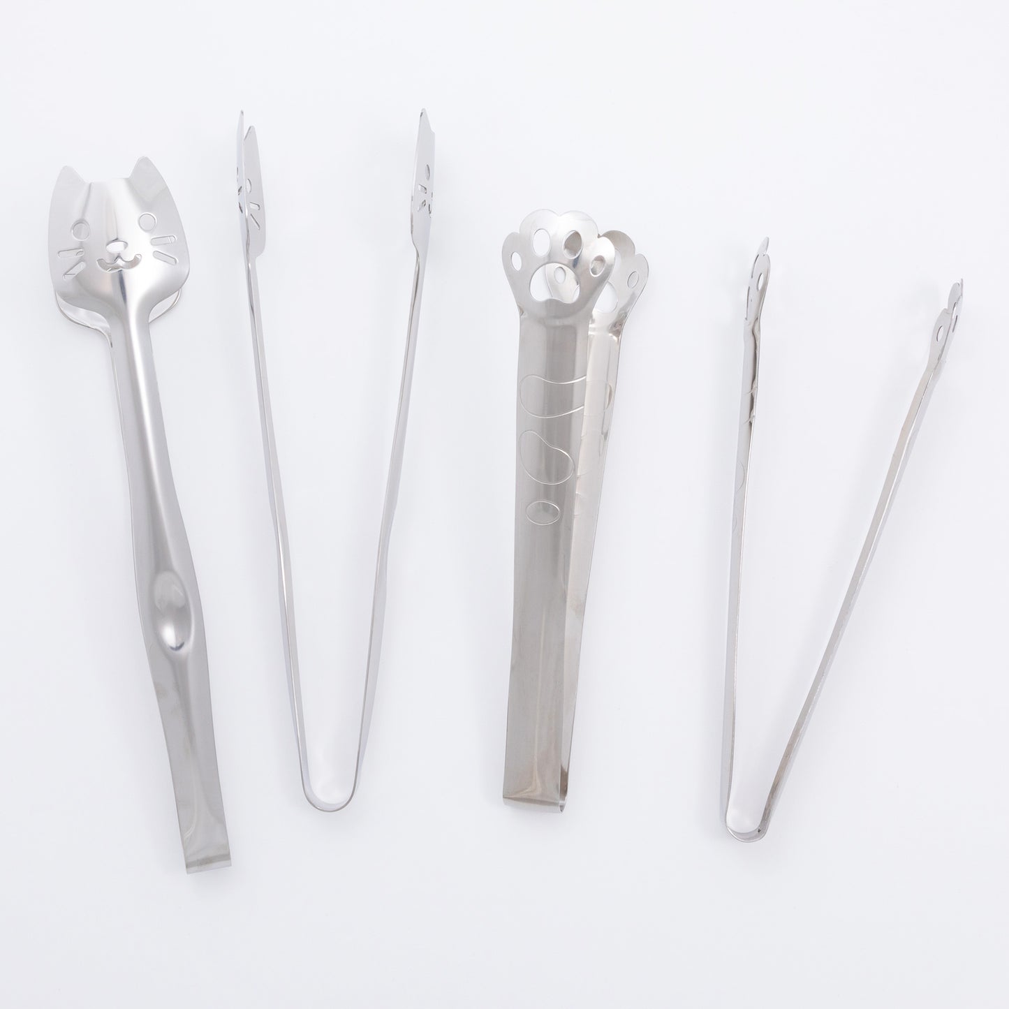 Set of silver kitchen tongs on a white background