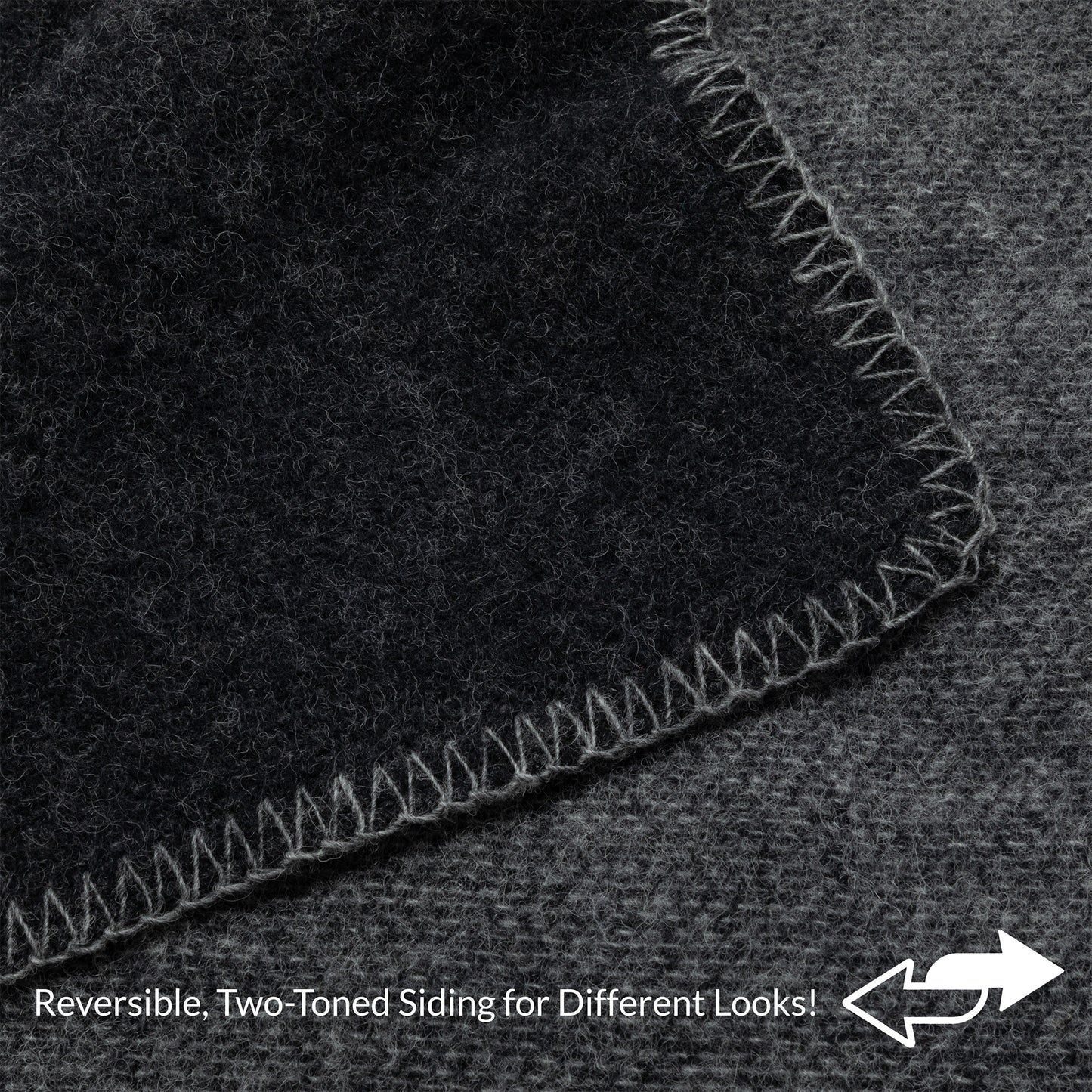 Close-up of a dark charcoal gray textured material with a lighter gray stitched border, showing a reversible two-toned side feature with text overlay at the bottom.